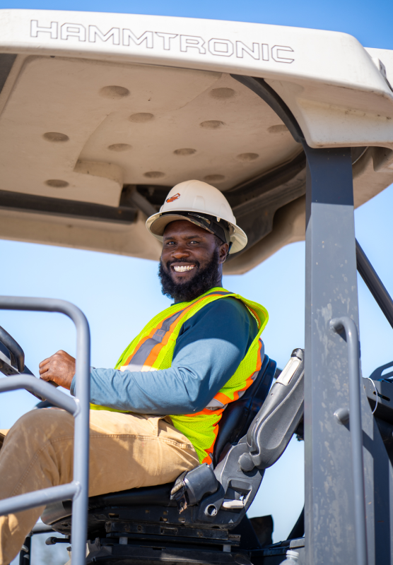 HBC, portrait, close up, employee sitting in machine, blue long sleeve shirt, smiling, white hard hat, hammtronic top, experience-best-of-both-worlds.png, About