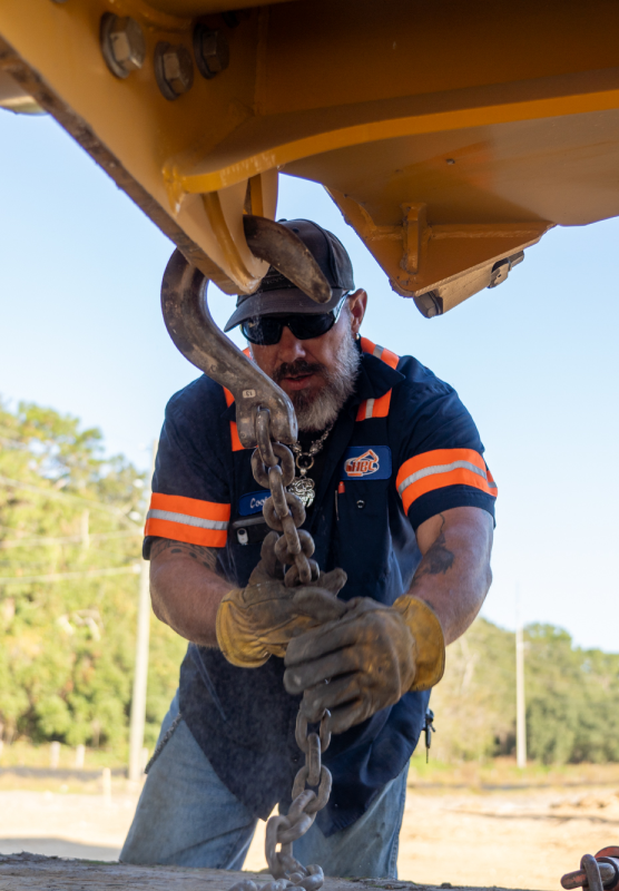 HBC, portrait, employee in blue orange short sleeve shirt, hook on equipment, holding chain with gloves, sunglasses, beard, life-at-hbc.png, Careers